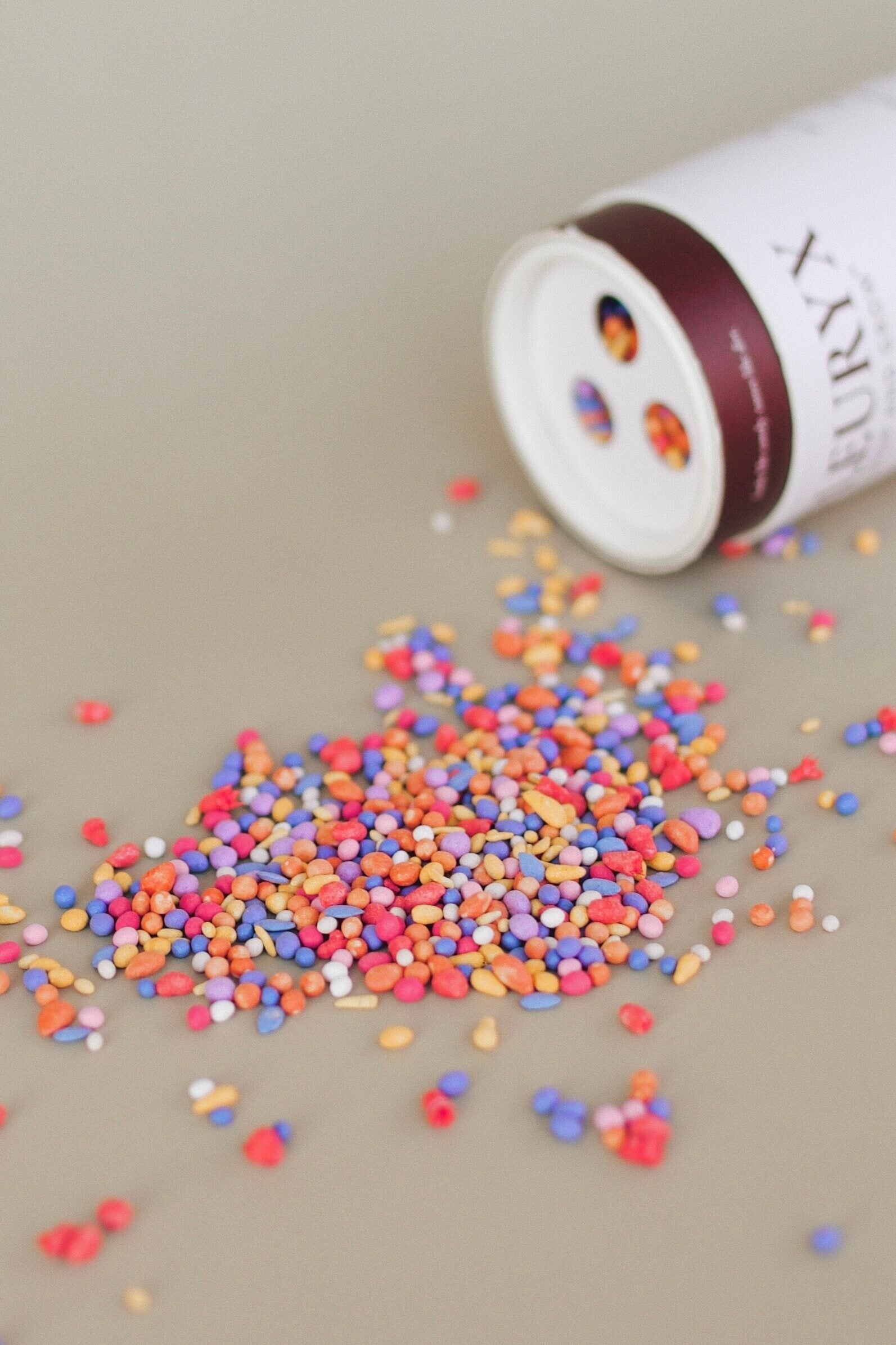 Fleuryx Drop & Grow colorful wildflower seed pellets spilling from shaker tube