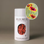 Fleuryx Blanketflower (Gaillardia aristata) Native Wildflower Seeds in a white seed shaker with a striped lid, showing red and yellow seed pellets from its colorful coated wildflower seeds and a photo of Blanketflower flowers.