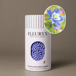 Fleuryx Blue Columbine (Aquilegia coerulea) Native Wildflower Seeds in a white seed shaker with a striped lid, showing blue and white colorful coated wildflower seeds and a photo of Blue Columbine flowers.