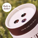Fleuryx Native Wildflower Mix with a built-in seed shaker top and colorful coated seed pellets visible through the three shaker holes.