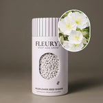 Fleuryx Pale Evening Primrose (Oenothera pallida) Native Wildflower Seeds in a white seed shaker with a striped lid, showing white seed pellets from its colorful coated wildflower seeds and a photo of Pale Evening Primrose flowers.