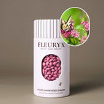 Fleuryx Swamp Milkweed (Asclepias incarnata) Native Wildflower Seeds in a white seed shaker with a striped lid, showing pink colorful coated wildflower seeds and a photo of Swamp Milkweed flowers.