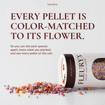 Fleuryx Native Wildflower Mix with colorful coated wildflower seed pellets spilled beside the shaker, with each pellet color-matched to its wildflower species.